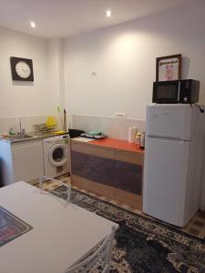 a kitchen with a white refrigerator and a washer at Ivone guest in Maisons-Alfort