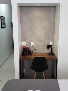 a desk with a black chair in a room at Studio_Copa_Clara in Rio de Janeiro