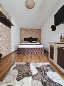 a bedroom with a bed and a large rug at Shelby Accommodation -Adult Only- in Sinaia
