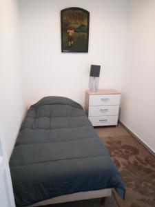 a bedroom with a bed and a dresser in it at Ivone guest in Maisons-Alfort