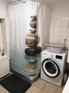 a shower curtain with a stack of donuts next to a washing machine at Ganzes Appartement in Seitenstetten in Seitenstetten Markt