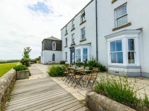 a wooden deck in front of a white building at No6 Sea Lane in Embleton