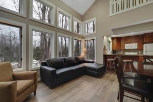 a living room with a couch and a table at 728 Disciples Village Condo in Boyne Falls