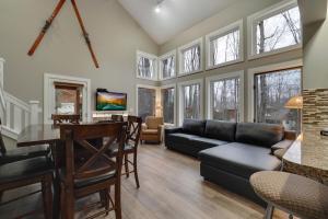 a living room with a couch and a table at 728 Disciples Village Condo in Boyne Falls