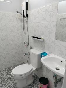 a bathroom with a toilet and a sink at Pimpisa Garden พิมพิศา การ์เด้นท์ in Ban Khuang Kom +61 photos