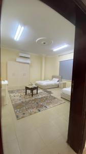 a large room with two beds and a table in it at فيلا سلطانة in Medina