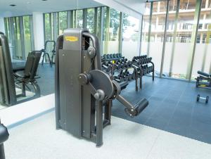 a gym with rows of chairs and a machine at Piano and Gold at The Lennox, Airport Residential in Accra