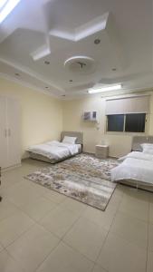 a large room with two beds and a rug at فيلا سلطانة in Medina