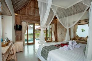 ein Schlafzimmer mit einem Bett mit Handtüchern darauf in der Unterkunft Amaya Sebatu Villa in Ubud