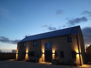 a brick house with solar panels on the roof at Lindum Barn, Ashlin Farm Barns in Lincoln