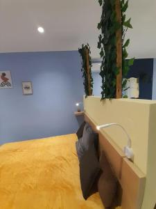 a room with a bed with a plant on the wall at Salavantinas House in Tavronitis +6 photos