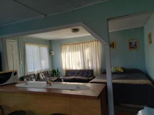 a bedroom with a bed and a large mirror at linda casa de campo in Futrono