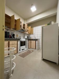 a kitchen with a white refrigerator in a room at Cerca de todo in Ciudad del Este