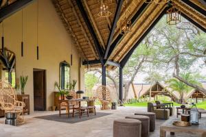 a large patio with chairs and tables and a building at Thornybush Game Lodge in Thornybush Game Reserve