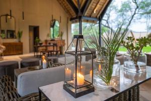 uma mesa com velas e vasos em Thornybush Game Lodge em Thornybush Game Reserve