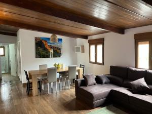 a living room with a couch and a table at El Caserio de Araña - Atlantic Blue Ocean in Los Cercados
