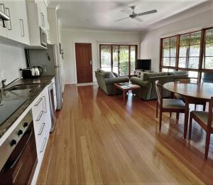 a kitchen and living room with a table and chairs at Tantallon in Berry