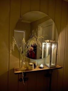 a mirror on a shelf in a bathroom at Kræmmervikveien 33 in Ballstad +20 photos