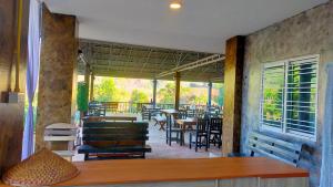 a porch with a table and chairs and a patio at Mong Homestay Resort in Pang Ung