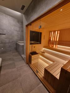 a sauna with a flat screen tv in a room at Apartman Drvorez Jahorina in Jahorina