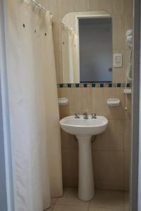 a bathroom with a sink and a mirror at La Posada de Salim in La Punta