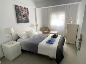 a bedroom with a bed with a blue towel on it at C. del Mar - de Luxe apartament Centrum Torrevieja in Torrevieja