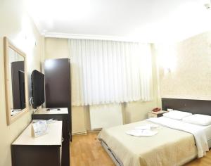 מיטה או מיטות בחדר ב-Kosar Hotel