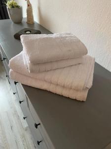 a pile of towels sitting on top of a table at B1 Ith Apartment in Coppenbrügge