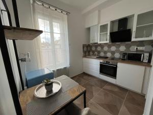 a kitchen with a table and a counter top at Studio 54 in Compiègne