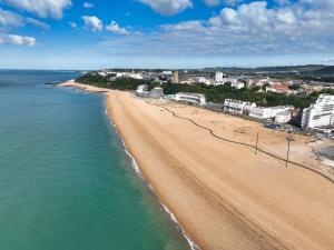 an aerial view of a beach with buildings and the ocean at 1 or 2 bed in Folkestones West End in Folkestone