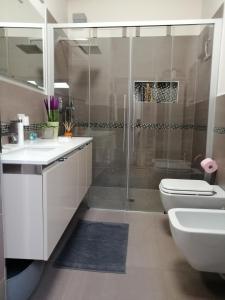 a bathroom with a sink and a toilet and a shower at Casa in residence - Padenghe sul Garda in Padenghe sul Garda +17 photos