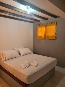 1 dormitorio con 1 cama con 2 toallas en HOSTERIA PUERTO BALBANERA, en Tonsupa