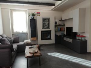 a living room with a couch and a table at Casa in residence - Padenghe sul Garda in Padenghe sul Garda