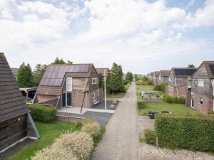 a row of houses with solar panels on their roofs at Welcoming holiday home in Grou with bubble bath in Grou