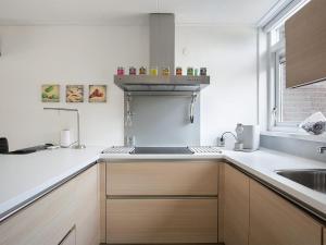 a kitchen with a sink and a counter top at Welcoming holiday home in Grou with bubble bath in Grou
