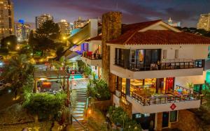 a building with a pool in front of a city at night at Hostel 32 in Punta del Este