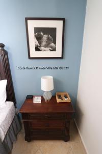 a table with a lamp on it next to a bed at Costa Bonita Private Villa 602 in Culebra