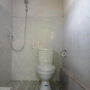 La salle de bains est pourvue d'une douche et de toilettes. dans l'établissement Bali Livin,tayehomestay, à Banjarangkan
