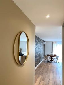 a hallway with a mirror on a wall with a table at Villa Contemporaine in Châtellerault