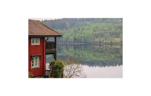 a picture of a house with a view of a lake at Awesome Home In Dals Lnged With House Sea View in Dals Långed