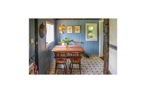 a dining room with a table and chairs at Awesome Home In Dals Lnged With House Sea View in Dals Långed