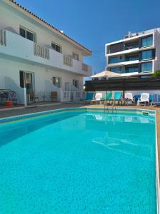a large swimming pool in front of a building at Diana Townhouse 5 in Paphos