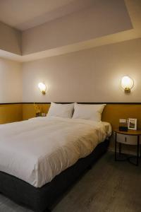 Postel nebo postele na pokoji v ubytování Giant Rich Hotel