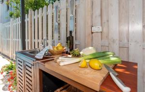 a wooden counter with vegetables on a cutting board at Nice Home In Vrsi Mulo With 5 Bedrooms, Sauna And Outdoor Swimming Pool in Vrsi
