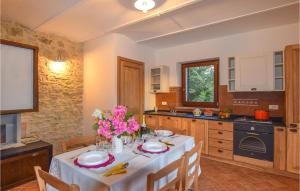 a kitchen with a table with flowers on it at Gorgeous Apartment In Avigliano Umbro With Kitchen in Avigliano