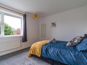 a bedroom with a bed and a large window at Beautiful Durham accommodation - Perfect for contractors in Shincliffe