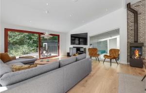 a living room with a couch and a fireplace at Nice Home In Nexø With Sauna in Neksø