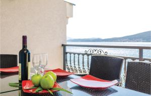 a table with a bottle of wine and pears on it at Apartment Baosici Baosici in Herceg-Novi