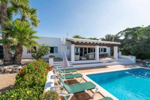 a villa with a swimming pool and a house at Bini Carmen in Binibeca
