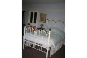 A bed or beds in a room at Bulmer Tye House 